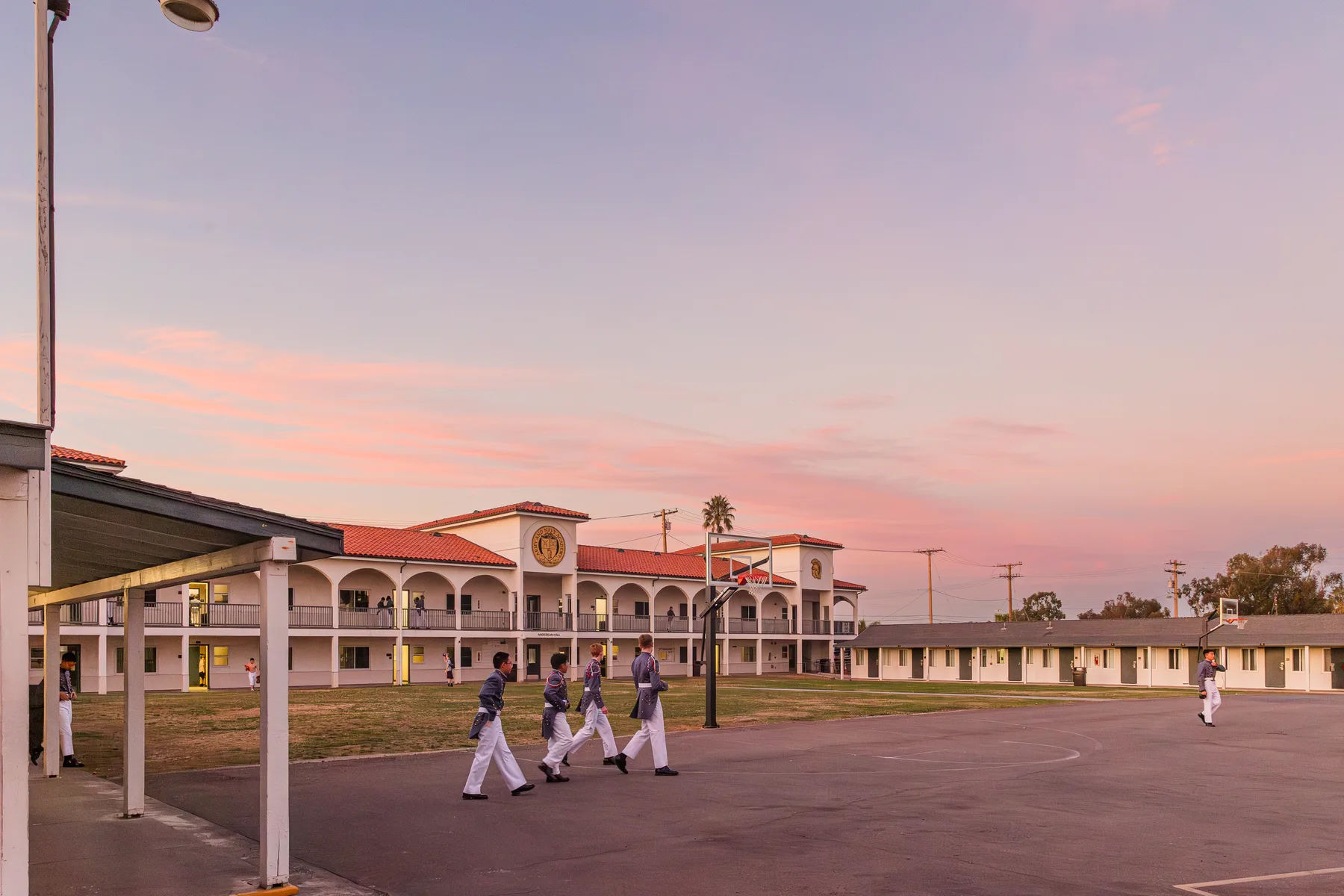 Army and Navy Academy cadets walking across campus at sunset